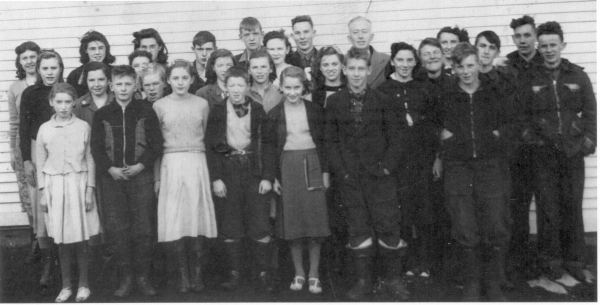 526: Group of 27 children. (circa 1950) [courtesy of Lorna Richardson] ** also see 527 **  Back-to-front, left-to-right,  Margie Norman (back), Beth Lambe (middle), Babe Ennis (front, white skirt);  Angela Ryan (back), Mary Finn (middle), Francis Barry (front);  Marie Ryan (back), Annie Norman (2nd from back, partially hidden), Madonna McCarthy (3rd  from back, blonde hair), Madonna Whelan (front, white skirt);  Gerard Lambe (back), Imelda Ryan (middle), Dave Ryan (front);  Paul McCarthy (back), Gwen Carroll (2nd from back), Noreen Ryan (3rd from back),  Mary Ennis (front); Camillus Dunphy (back), Teresa Whelan (middle, big smile),  Patrick Lambe (front); Mr. Denis Patrick Barry (back, schoolmaster), Marie Counsel, Kevin Ryan,  Betty Ennis (back), Thomas Barry (front), Adrian Ryan, Joseph Dunphy, Kevin Carroll.  - Francis Barry (of Thomas Barry &amp;amp; Catherine Corrigan)  - Thomas Barry (of Thomas Barry &amp;amp; Anne Dollimont)  - Gwen Carroll (of Michael Carroll &amp;amp; Josephine Barry)  - Kevin Carroll (of Michael Carroll &amp;amp; Josephine Barry)  - Marie Counsel (of Michael Counsel &amp;amp; Mary Anne Barry)  - Camillus Dunphy (of Thomas Dunphy &amp;amp; Anastasia Carroll)  - Joseph Dunphy (of Thomas Dunphy &amp;amp; Anastasia Carroll)  - Babe Ennis (of Vincent Ennis &amp;amp; Mary Carroll)  - Betty Ennis (of Vincent Ennis &amp;amp; Mary Carroll)  - Mary Ennis (of Vincent Ennis &amp;amp; Mary Carroll)  - Mary Finn (of Patrick Finn &amp;amp; Helena Hayward)  - Beth Lambe (of James Lambe &amp;amp; Catherine Rodgers)  - Gerard Lambe (of Peter Lambe &amp;amp; Anne Norman)  - Patrick Lambe (of Peter Lambe &amp;amp; Anne Norman)  - Madonna McCarthy (of James McCarthy &amp;amp; Mary Ellen Barry)  - Paul McCarthy (of Thomas McCarthy &amp;amp; Margaret Whelan)  - Annie Norman (of John Norman &amp;amp; Mary Farget)  - Margie Norman (of Charles Norman &amp;amp; Elizabeth Anne Barry)  - Adrian Ryan (of Albert Ryan &amp;amp; Catherine Nolan)  - Angela Ryan (of Michael Ryan &amp;amp; Petronella Whelan)  - David Ryan (of Jeremiah Ryan &amp;amp; Josephine Lambe)  - Imelda Ryan (of Jeremiah Ryan &amp;amp; Josephine Lambe)  - Kevin Ryan (of Albert Ryan &amp;amp; Catherine Nolan)  - Marie Ryan (of Joseph Ryan &amp;amp; Ursula Barry)  - Noreen Ryan (of Albert Ryan &amp;amp; Catherine Nolan)  - Madonna Whelan (of Leo Whelan &amp;amp; Elizabeth Bishop)  - Teresa Whelan (of Leo Whelan &amp;amp; Elizabeth Bishop)